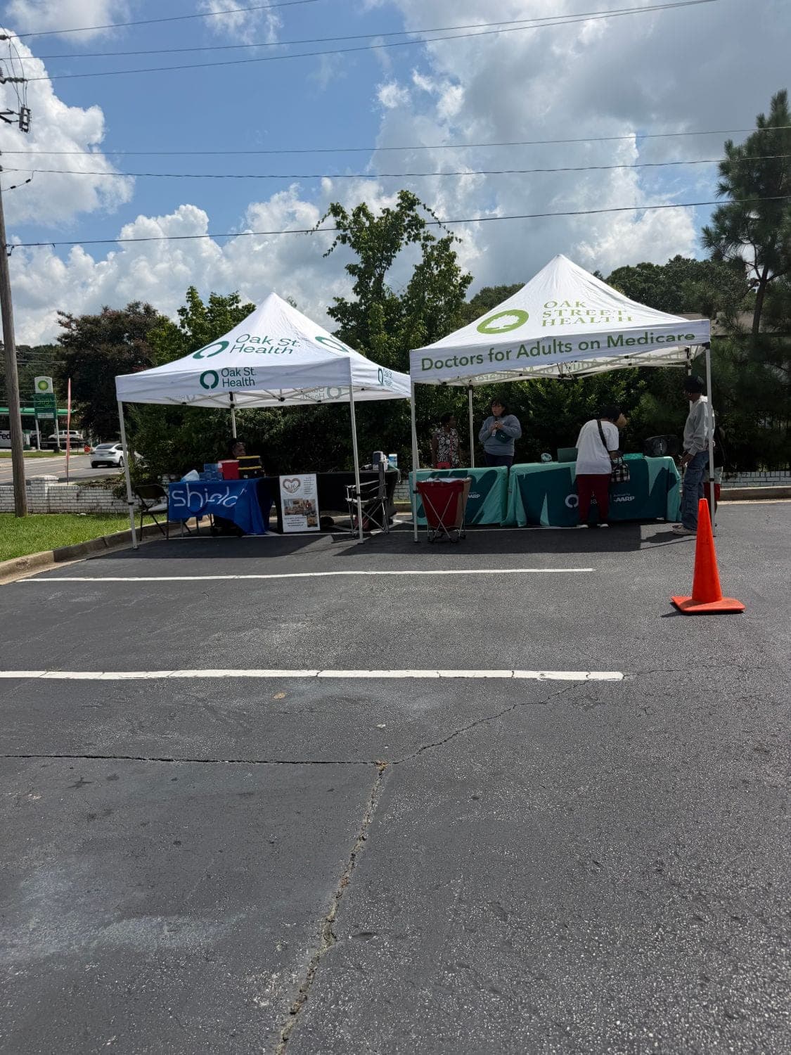 Oak Street Health tents and community partner tables at the food pantry outreach event in East Point, Georgia