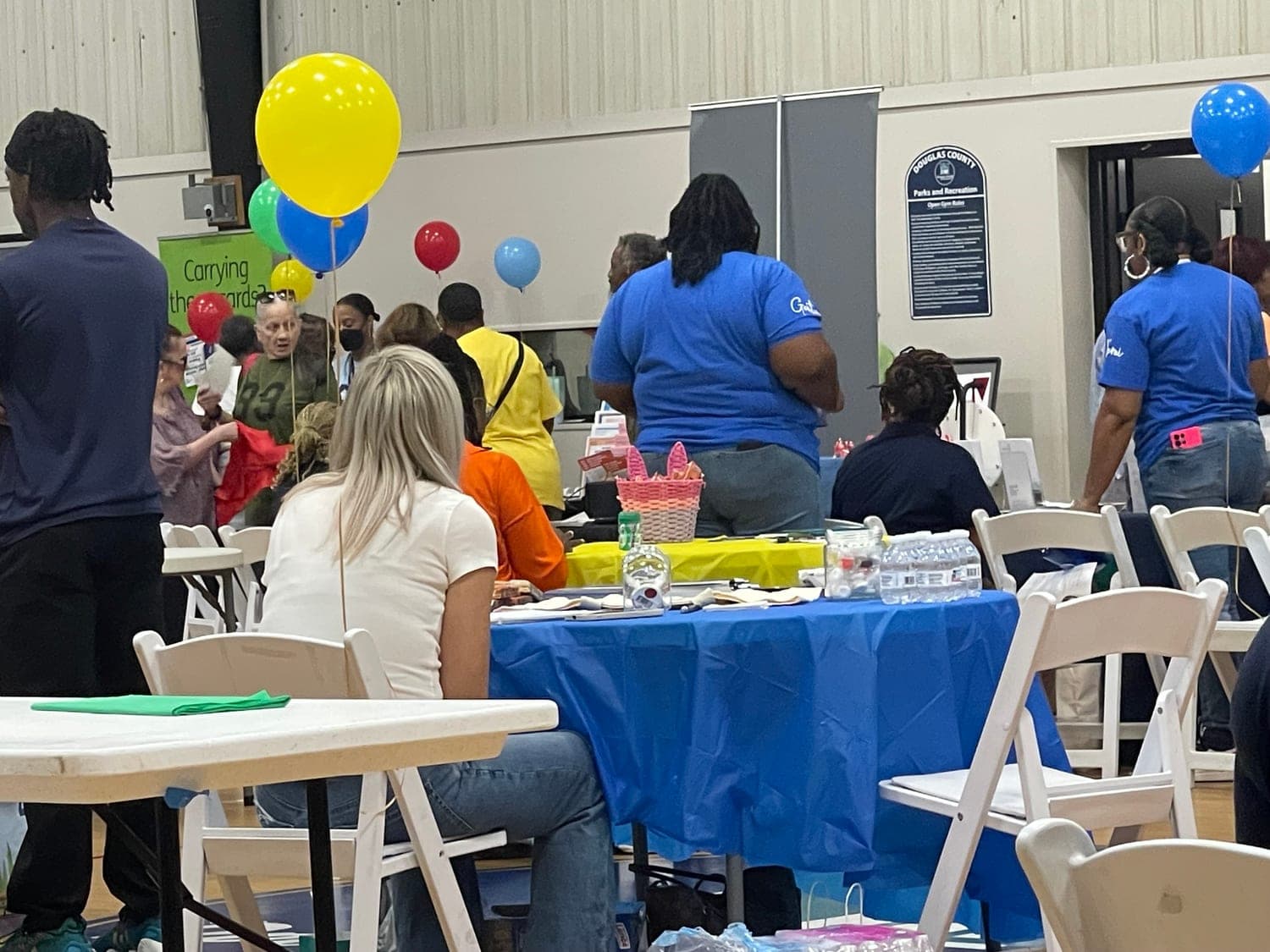 Families and vendors at a community health fair where Healthcare Support Home Care had a table