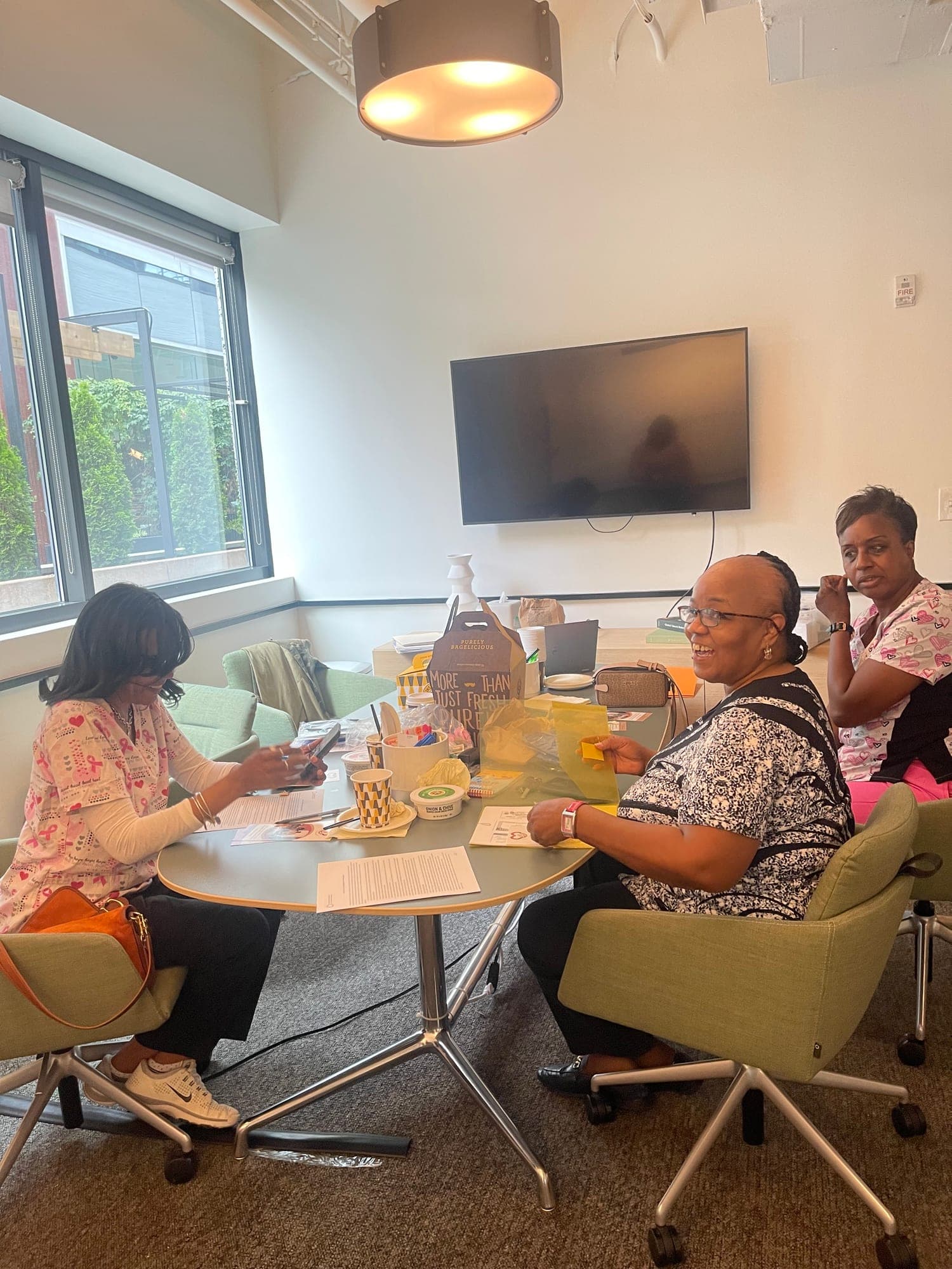 Kendra, the agency's founder, sitting with a community member during an activity session